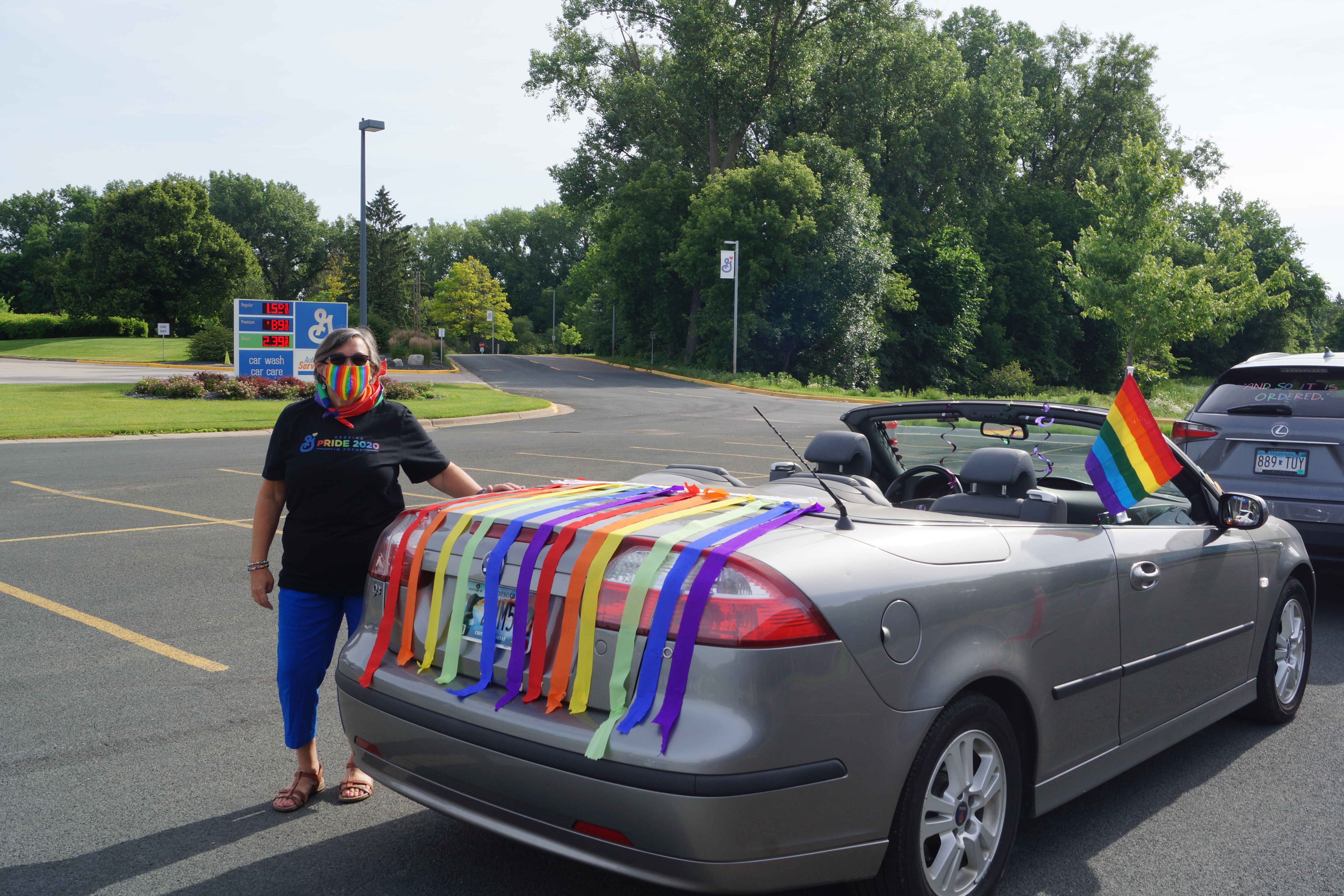 Woman next to car in Pride Ride